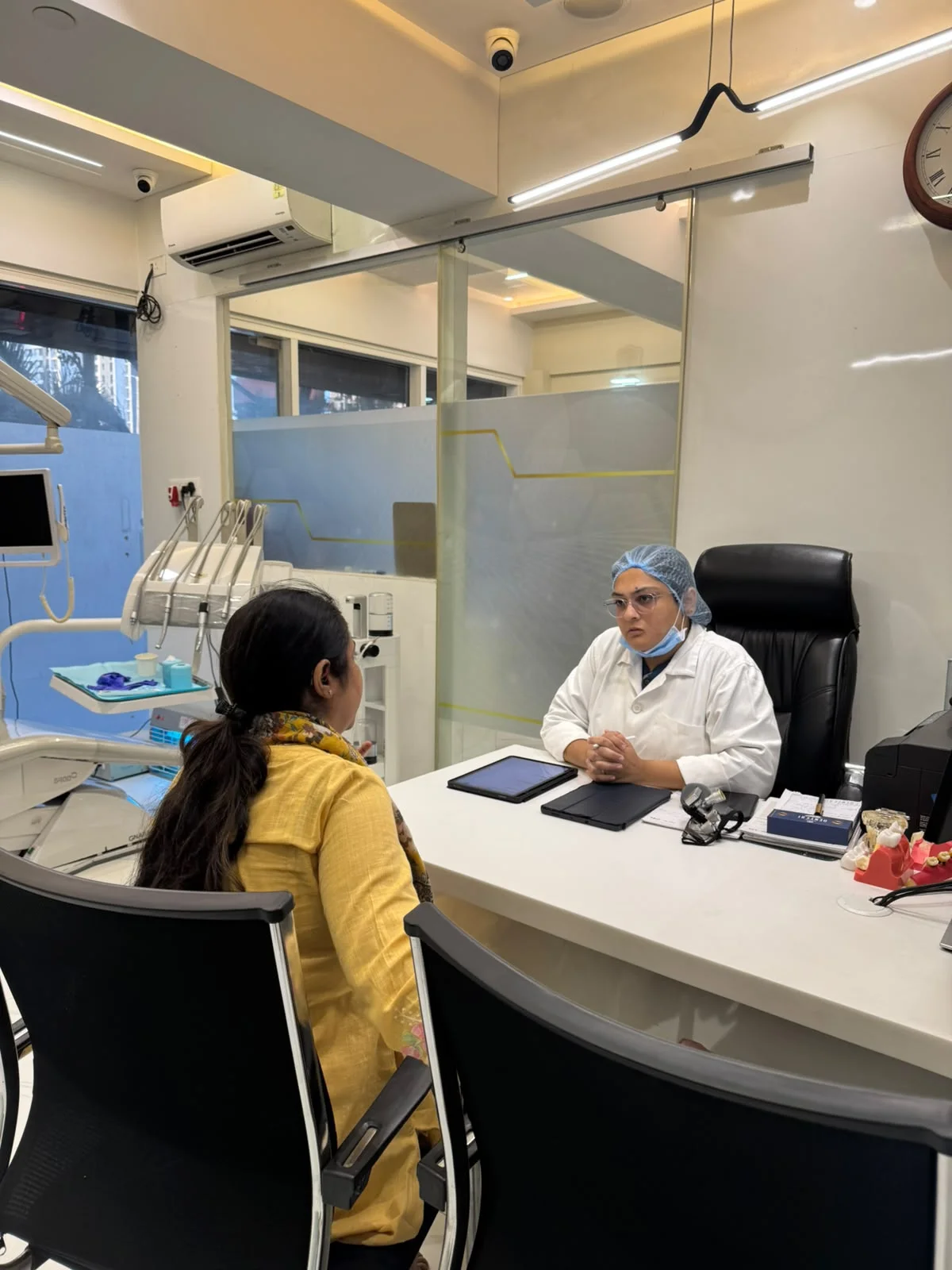 Dentist consulting a patient at the clinic desk