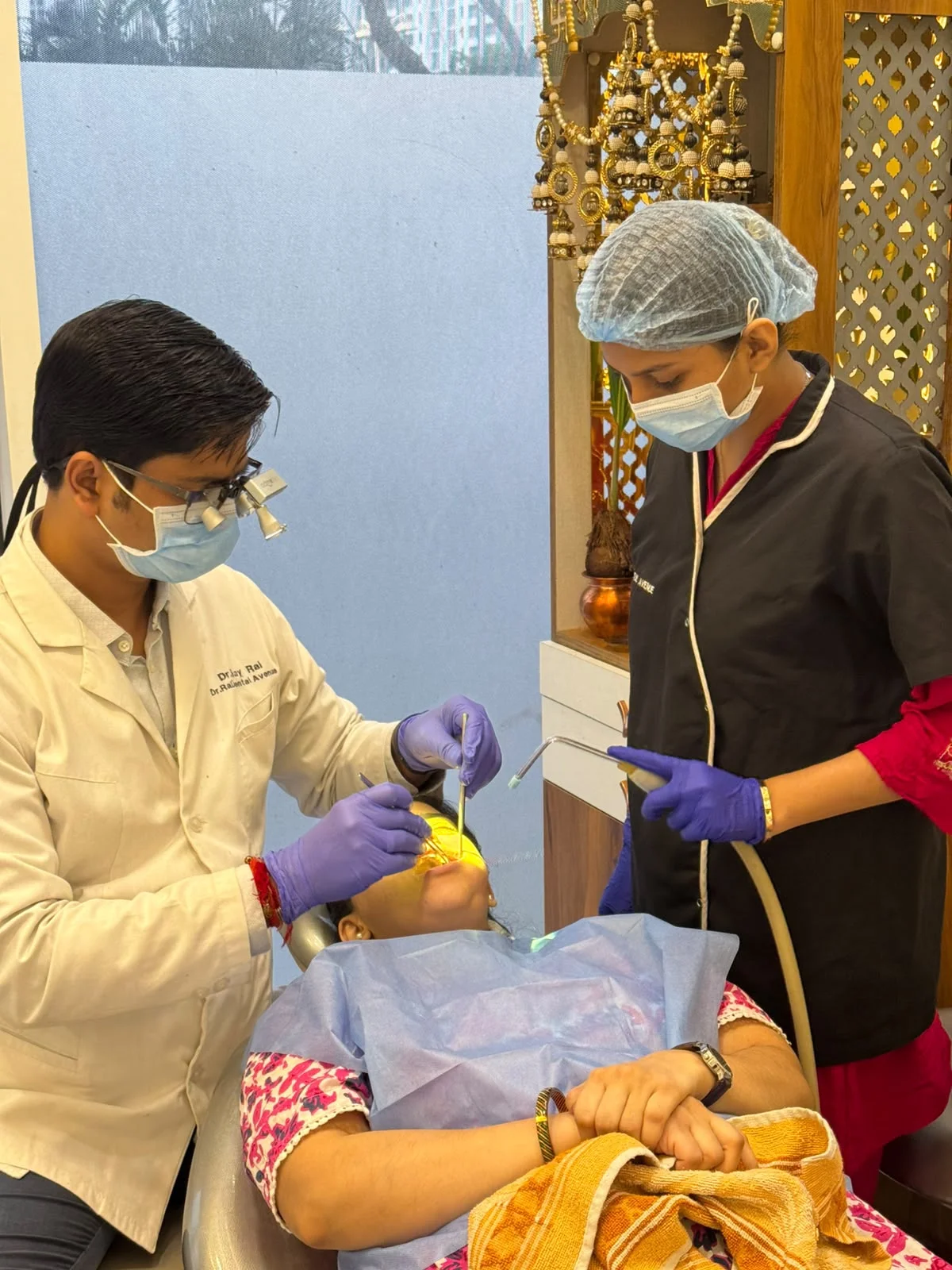 Dentist and assistant treating a patient