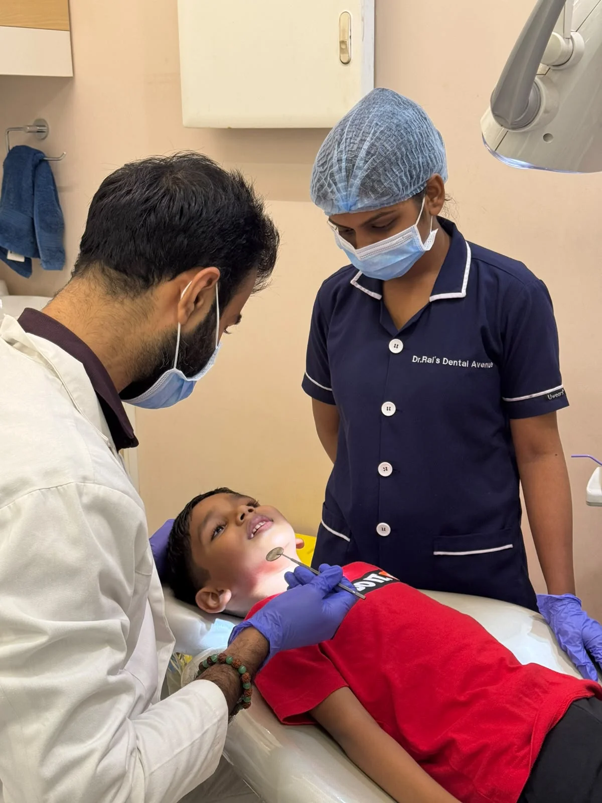 Dentist examining a child at the clinic
